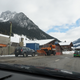 Dacia Duster with Swiss plates, Unimog snow clearer on snow chains, Subaru Impreza wagon carbagerun contestant, mountains. 14:16